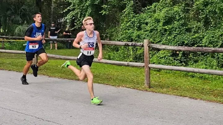Two runners on the course at the Whispering Pines XC Invitational
